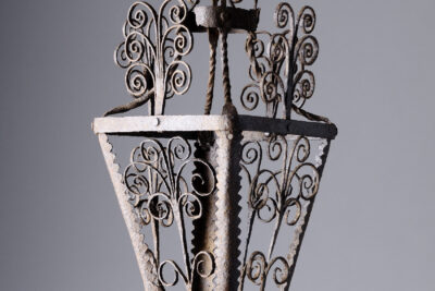 Lanterne ancienne en fer forgé ornée de volutes décoratives, suspendue sur fond neutre - Agrandir l'image 7 sur 8, fenêtre modale
